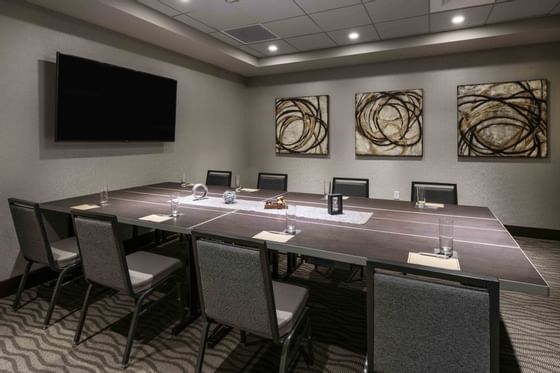 conference room with long table and television at the end