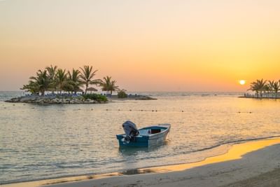 An Island & a boat during Sunset near Holiday Inn Montego Bay