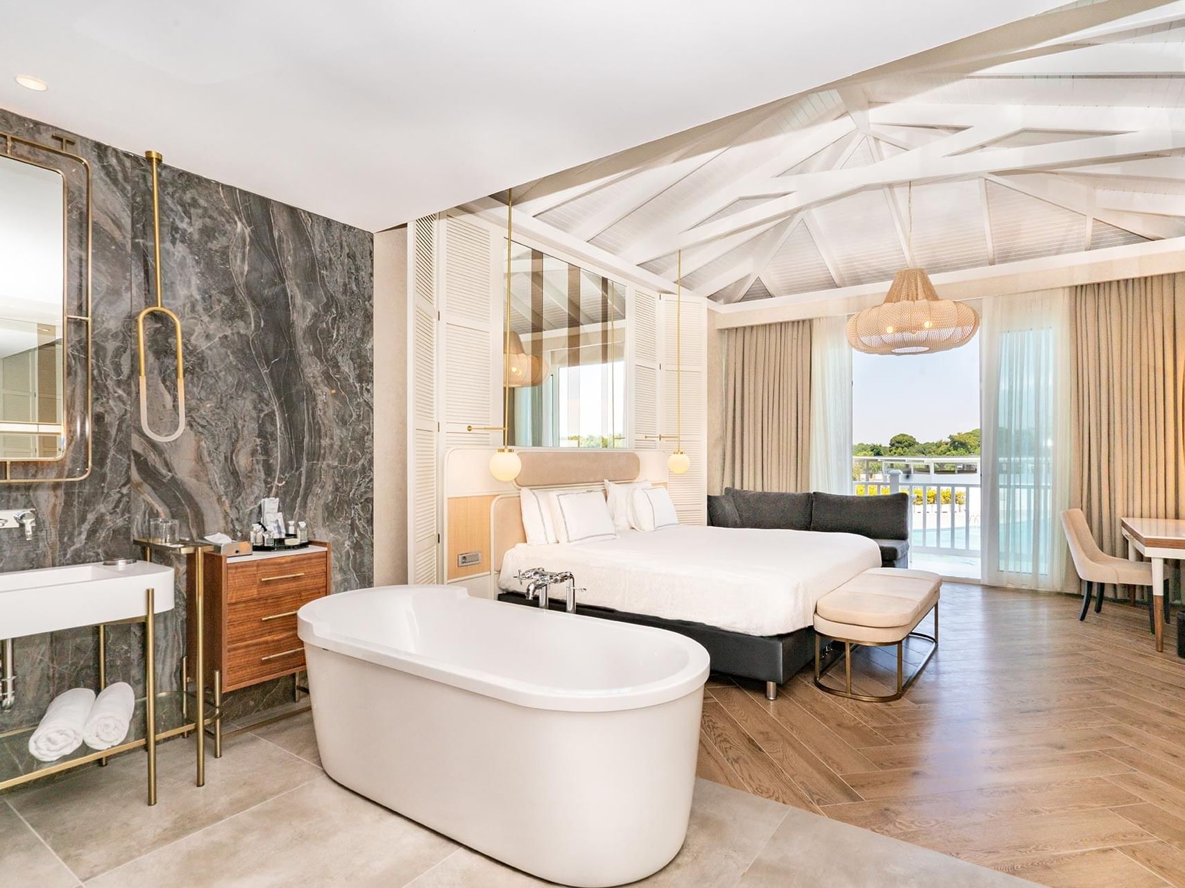 Cozy bed, lounge and bathtub in Maldive House at Titanic Deluxe Golf Belek