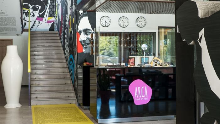 The reception desk by the stairway at Arca Street Art Hotel