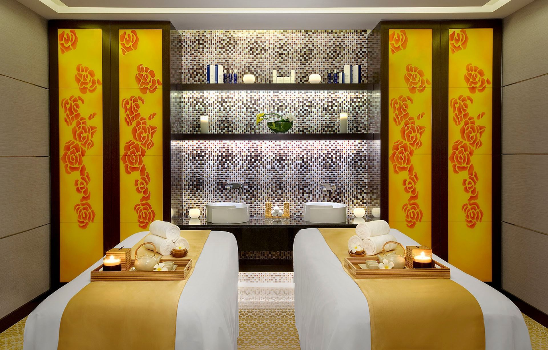 Luxurious interior with two massage beds, yellow accents, and tiled wall in Spa Jardin at DAMAC Maison Cour Jardin
