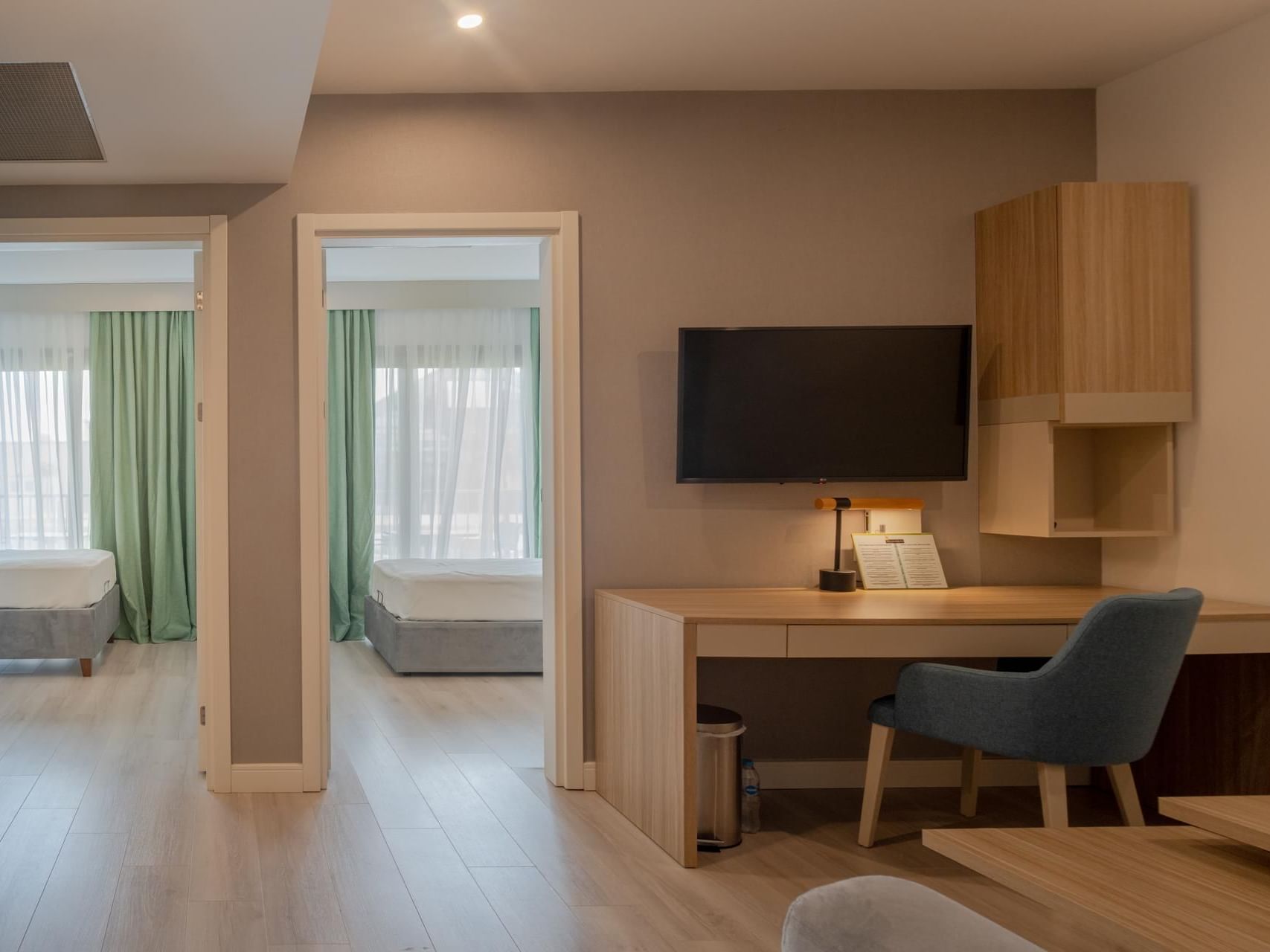 Separating bed areas with workspace and TV in Interconnected Suites at The Hub Acunmeyda