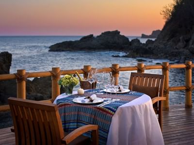Outdoor dining table with ocean view at Cala de Mar