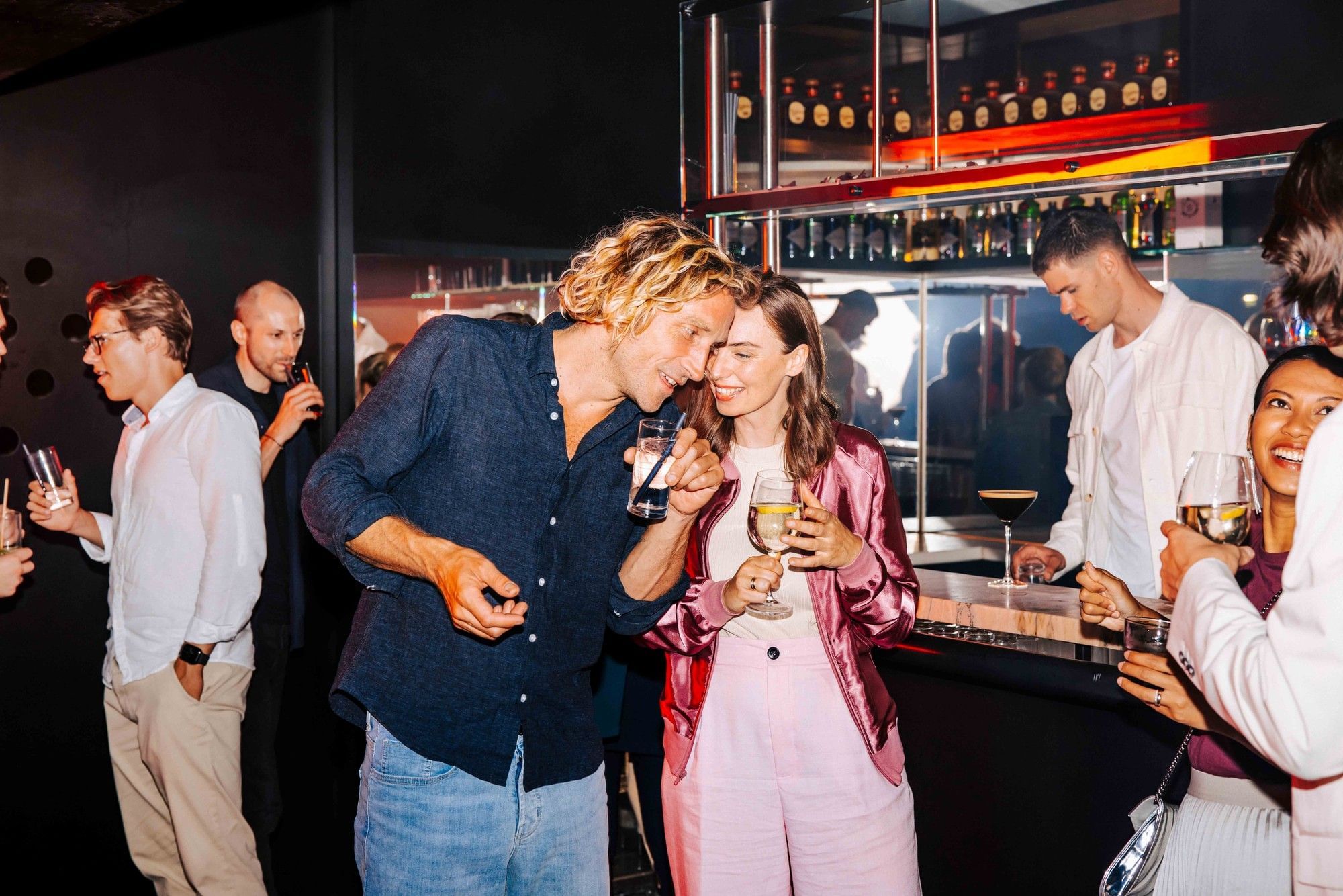 Nightlife in Vienna with people at a stylish bar and a lively evening atmosphere