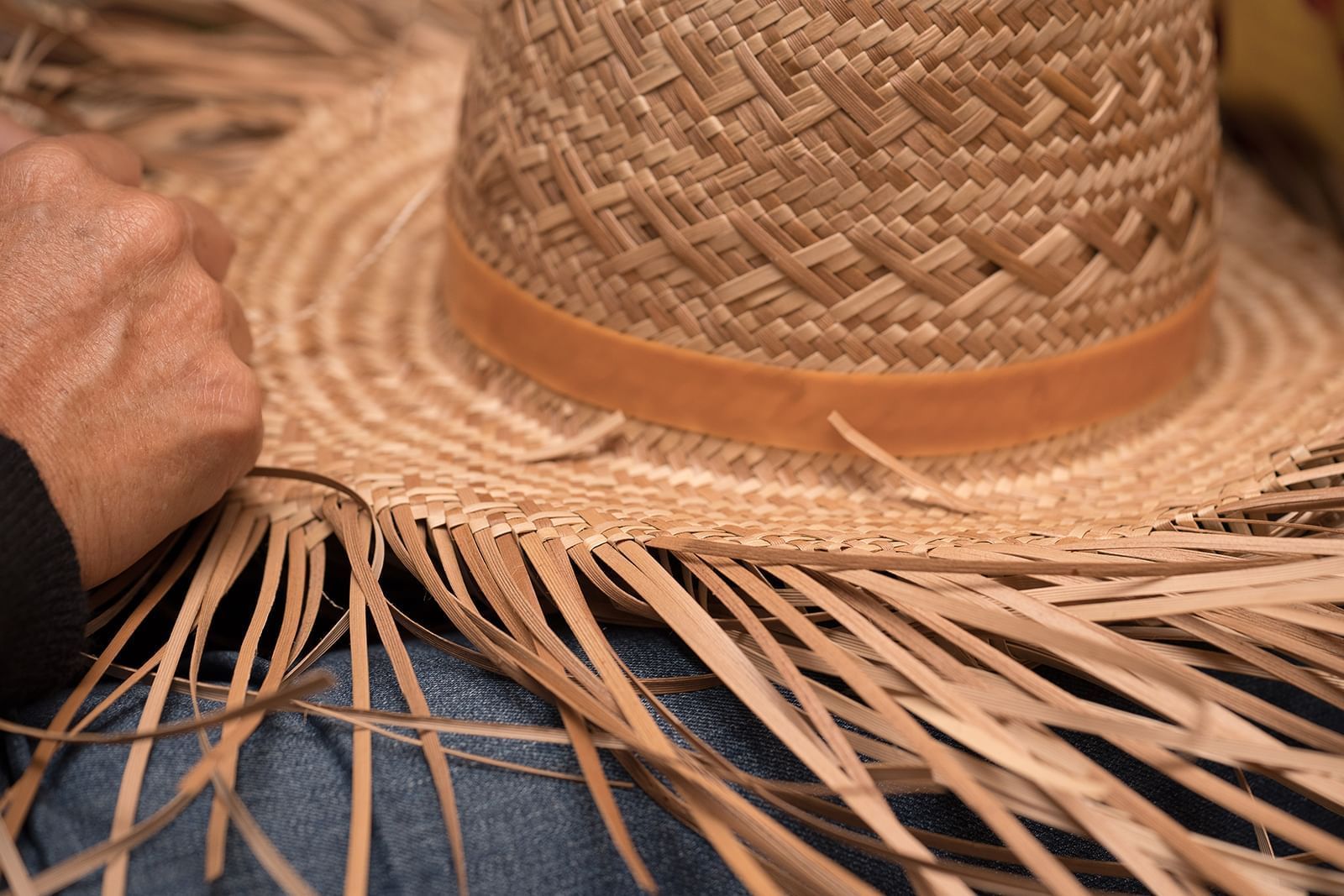 Guest weaving a hat at Ka'anapali Beach Hotel Hawaii