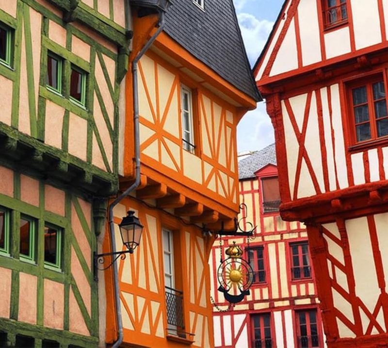 View of a street lined with colourful buildings near Oceania Hotels
