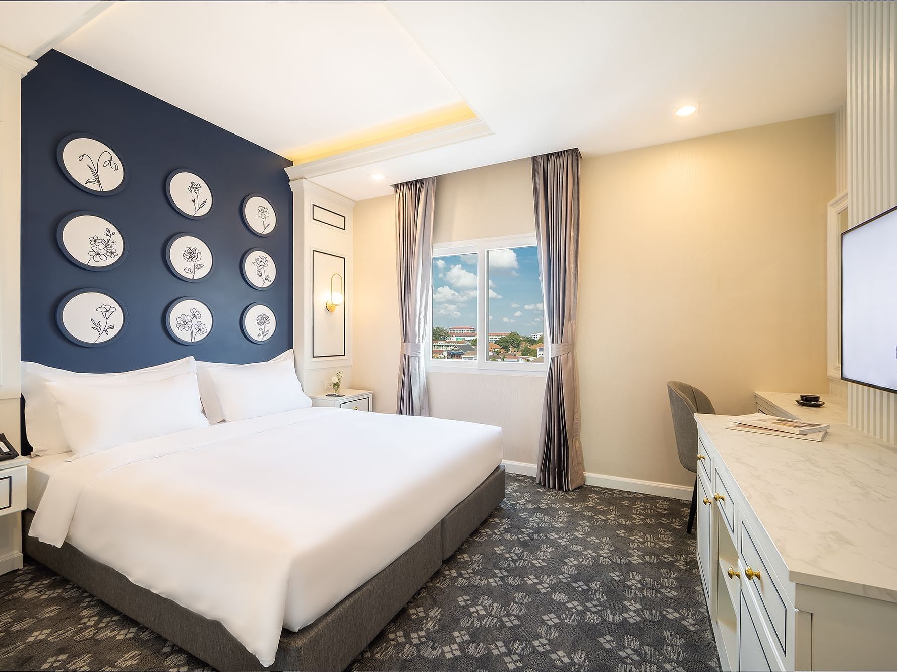 Comfy bed with TV area in Superior City View at Eastin Hotels