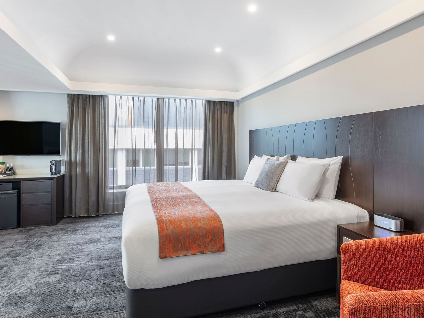 King bed in Deluxe Junior Suite at James Cook Grand Chancellor