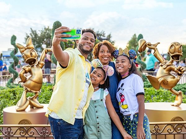 Family taking selfie in Walt Disney World’s Magic Kingdom near Lake Buena Vista Resort Village & Spa