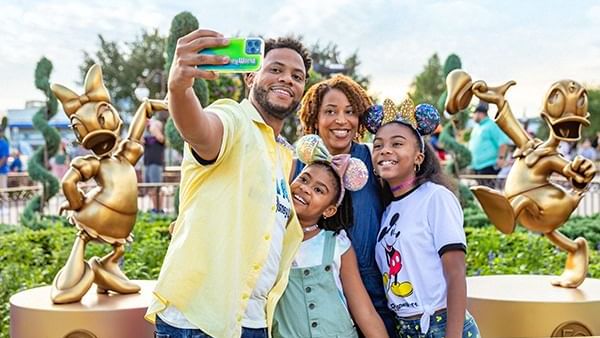 Family taking selfie in Walt Disney World’s Magic Kingdom near Lake Buena Vista Resort Village & Spa