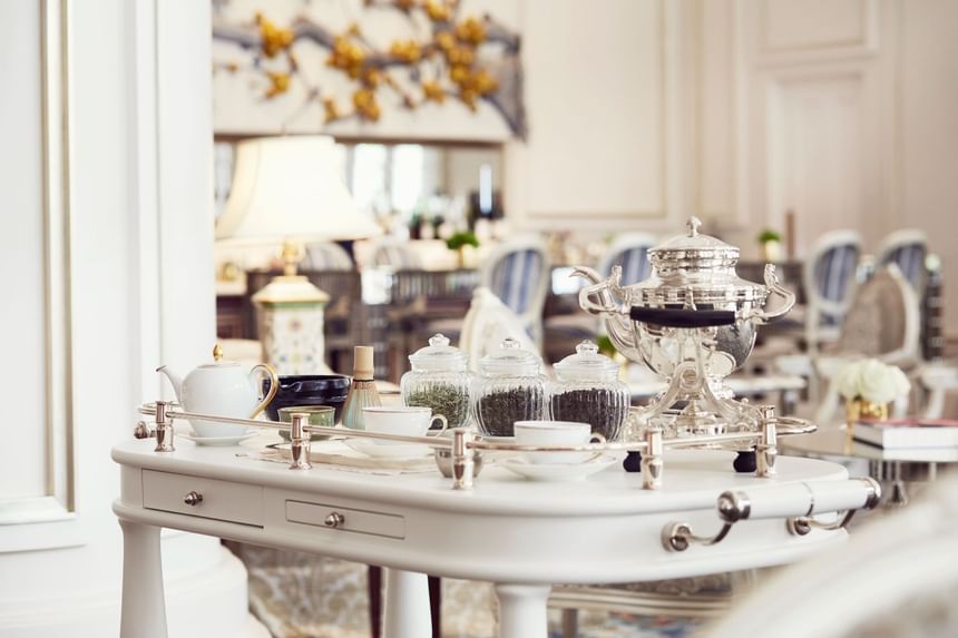 Elegant tea service with silver teapot and fine china on a stylish cart at Park Hyatt Saigon