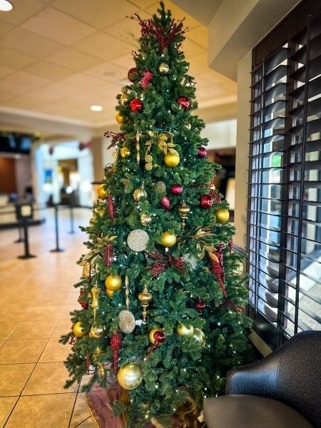 A stunning Christmas tree bringing holiday cheer to the lobby of Rosen Inn at Pointe Orlando, a family-friendly hotel on International Drive.