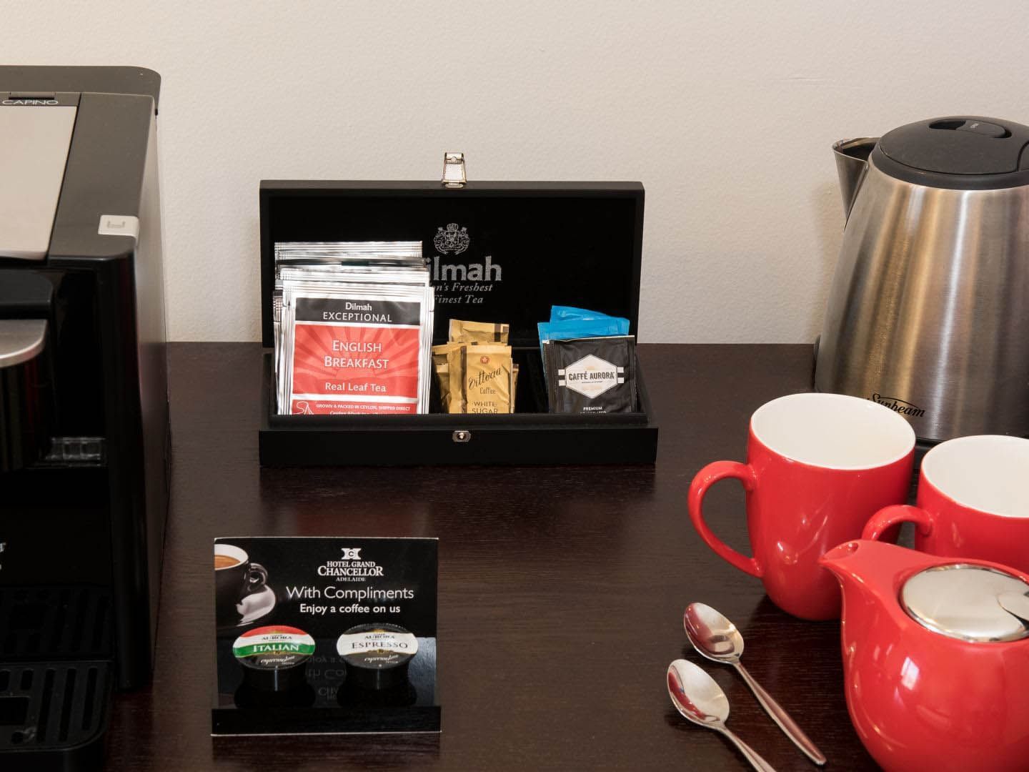 Sashay packets, mugs & a kettle on a table in Executive King Plus at Grand Chancellor Adelaide