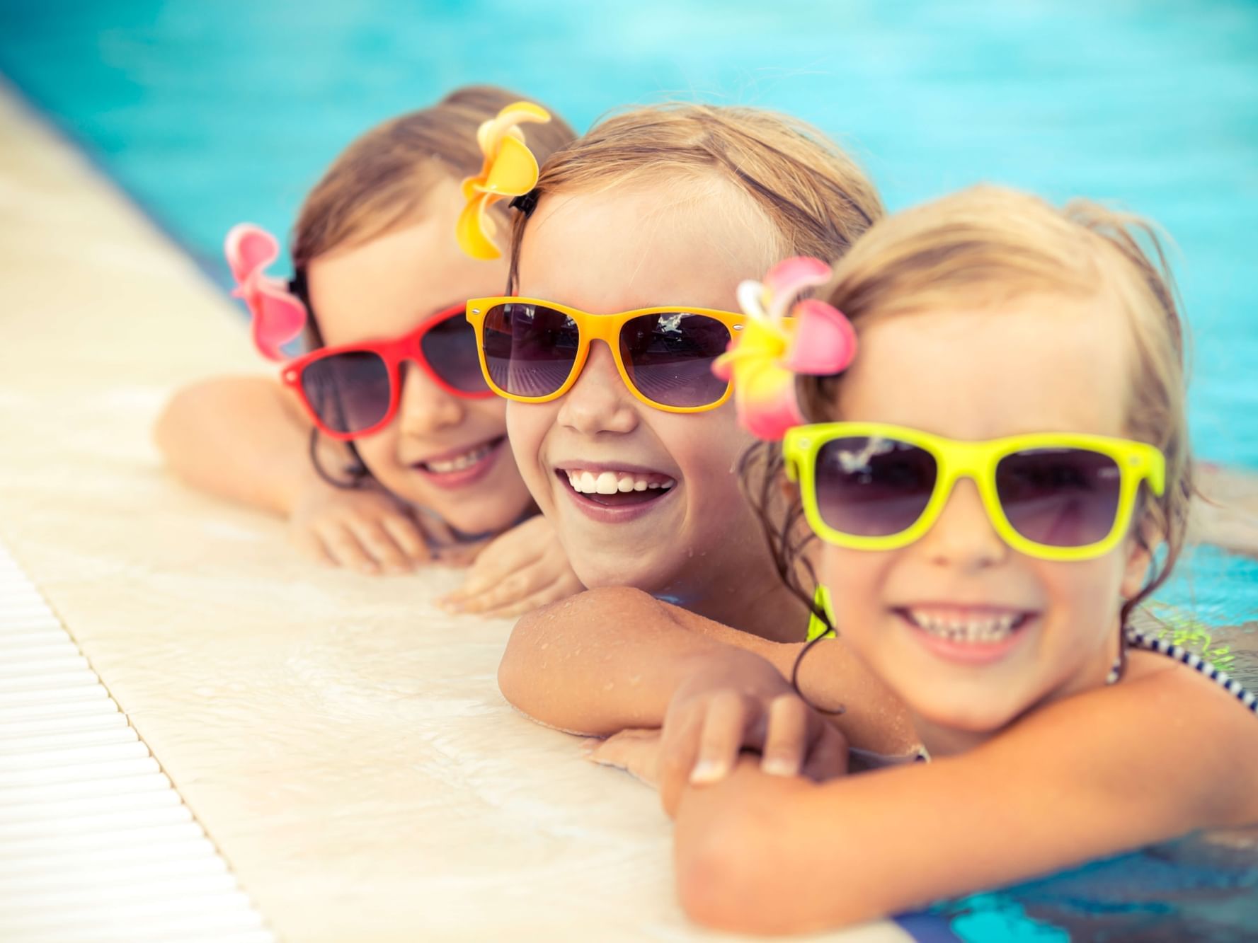 3 girls in the poolside with sunglasses at Ethan Allen Hotel