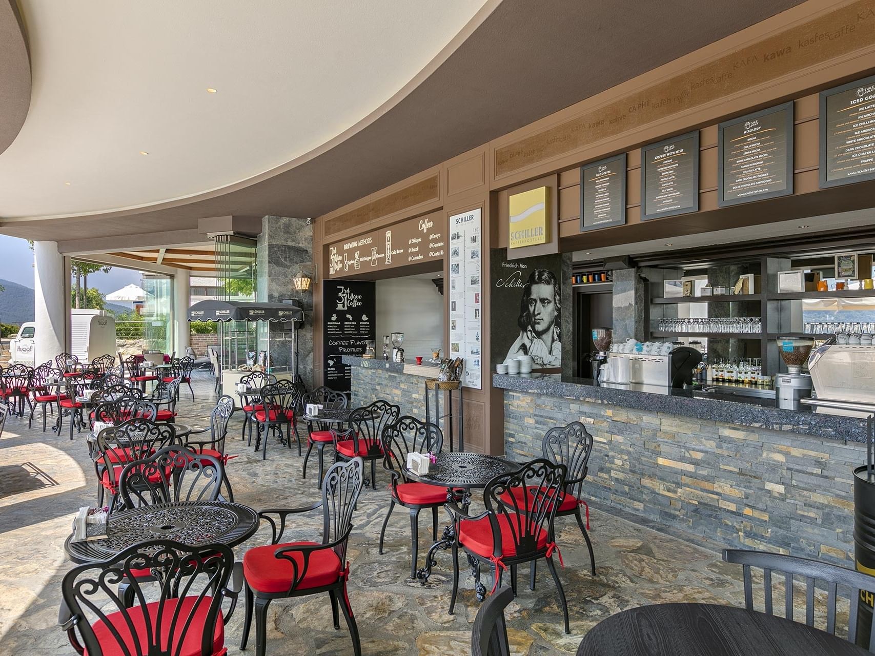 Stylish open-air coffee shop with shelves and counters at Titanic Luxury Collection Bodrum.