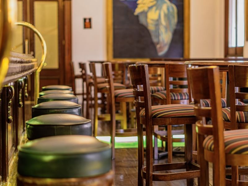 Bar 1900 area with bar stools at Gamma Hotels