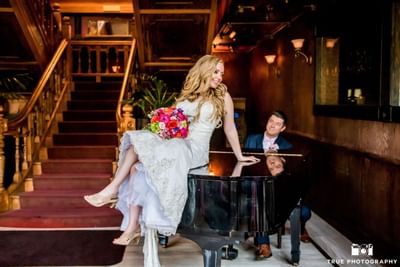 Bride and groom by a piano at Horton Grand Hotel