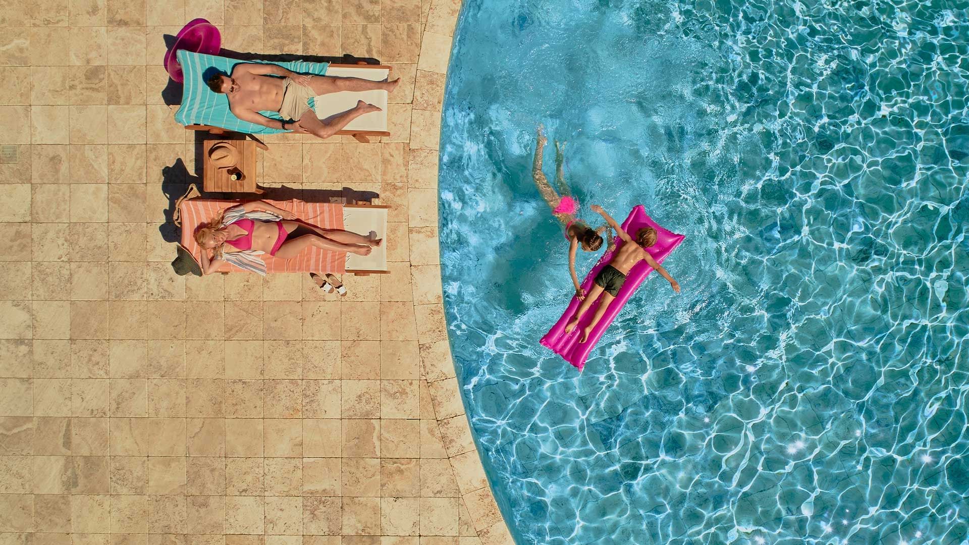 Aerial view of a family in the pool area, Falkensteiner Hotels