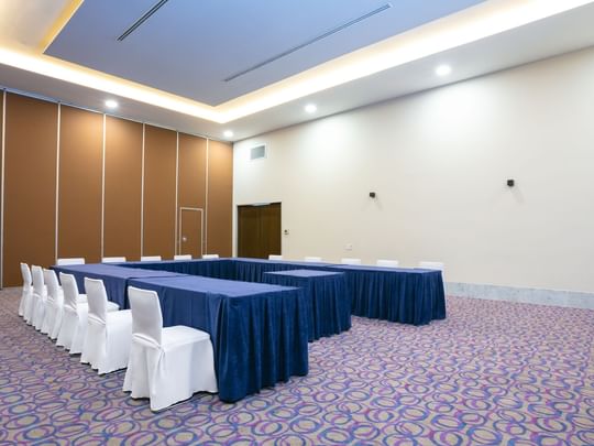 Alameda event room with white chairs and blue tables at Camino Real Guadalajara in Zapopan
