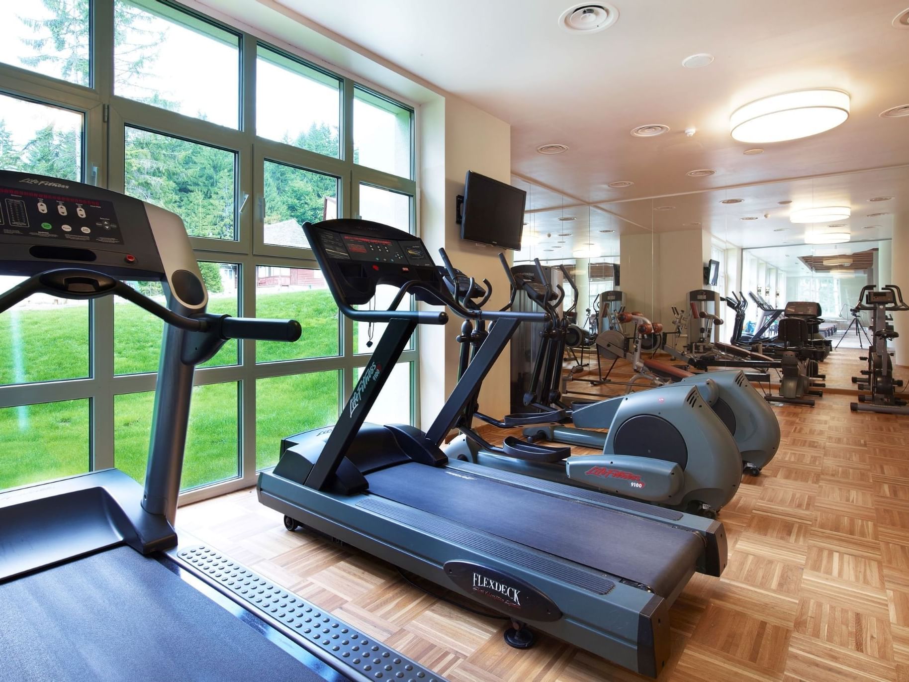 Treadmills lined up in Fitness Room at Ana Hotels Sport Poiana Braşov