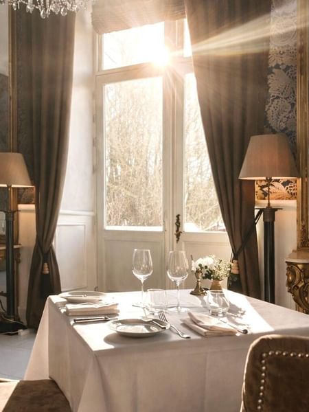 Elegantly set dining table with wine glasses and cutlery in The Terrace at Kokkedal Slot Copenhagen by Warwick, Horsholm.