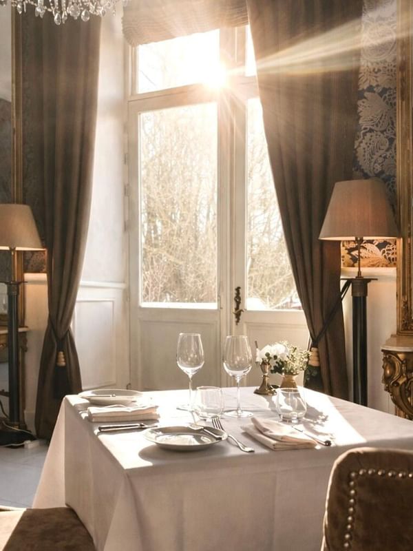 Elegantly set dining table with wine glasses and cutlery in The Terrace at Kokkedal Slot Copenhagen by Warwick, Horsholm.