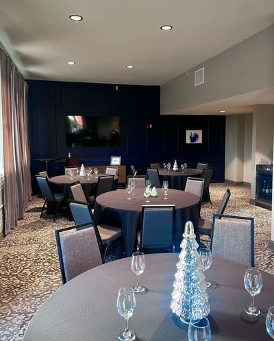 The Alcove event space set up with four round tables at Hotel at Old Town