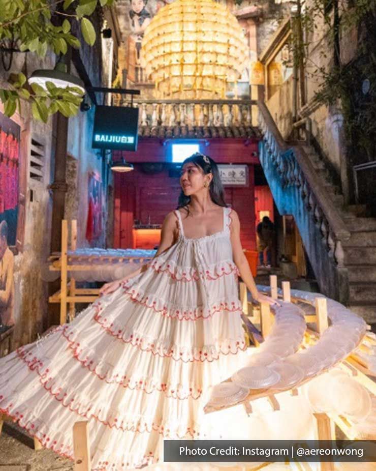 Lady wearing a flowy dress posing in Kwai Chai Hong street, a famous attraction near Imperial Lexis Kuala Lumpur