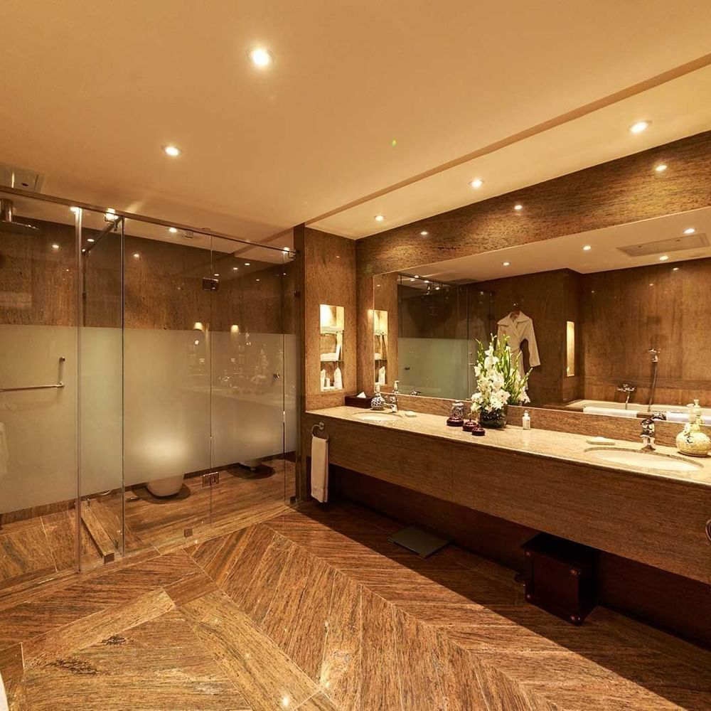 Elegant bathroom with marble floors and a walk-in shower at Islamabad Serena Hotel.