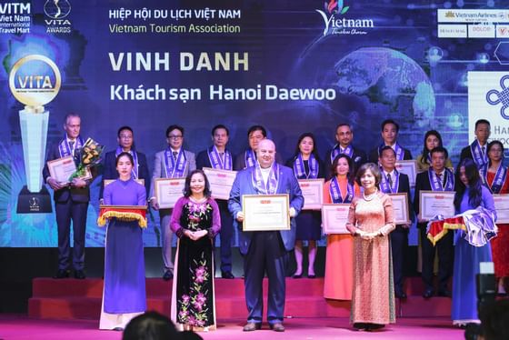People on stage in an Award ceremony at Hanoi Daewoo Hotel
