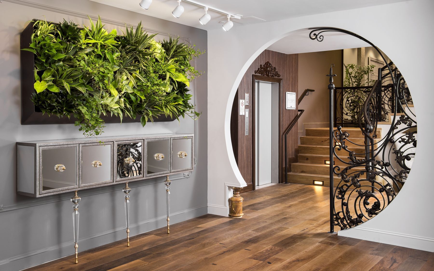 A foliage & stairway in the hotel lobby at Ivey's Hotel