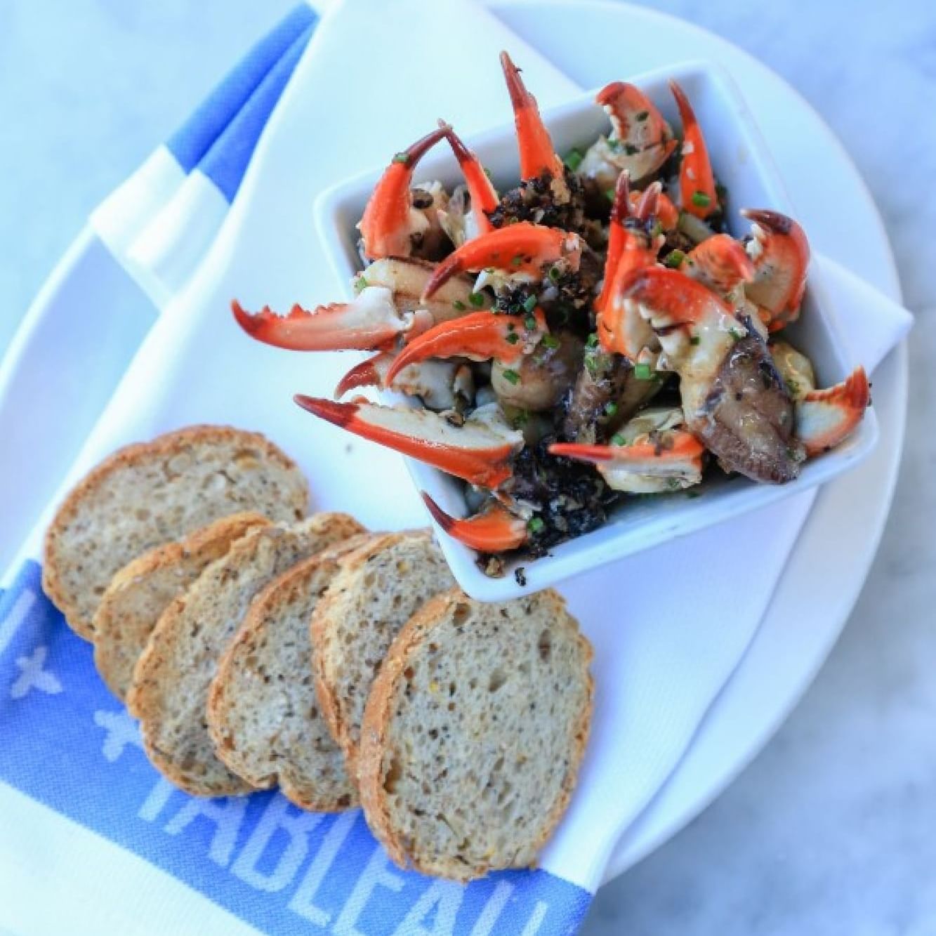 Crabs and bread served at Tableau near Andrew Jackson Hotel