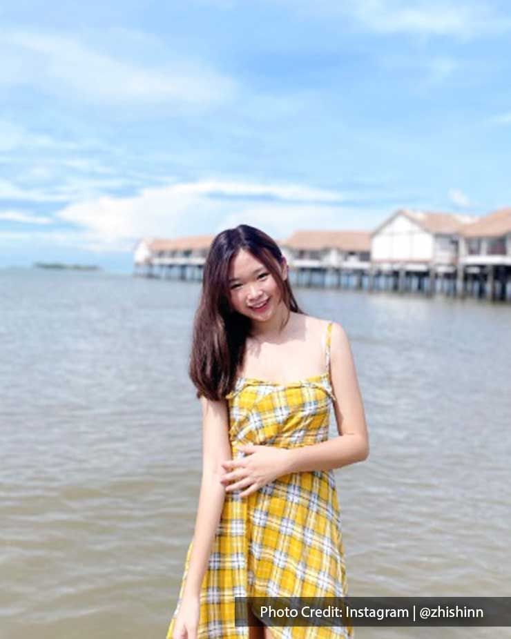 a girl wearing a yellow plaid dress with the sea view behind her at Lexis PD Resort