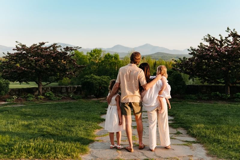 Family standing together on a stone pathway and admiring mountain views at Mountain View Grand Resort & Spa