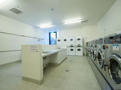 The Laundry is equipped with washing machines, dryers, ironing board, sink & clothes lines