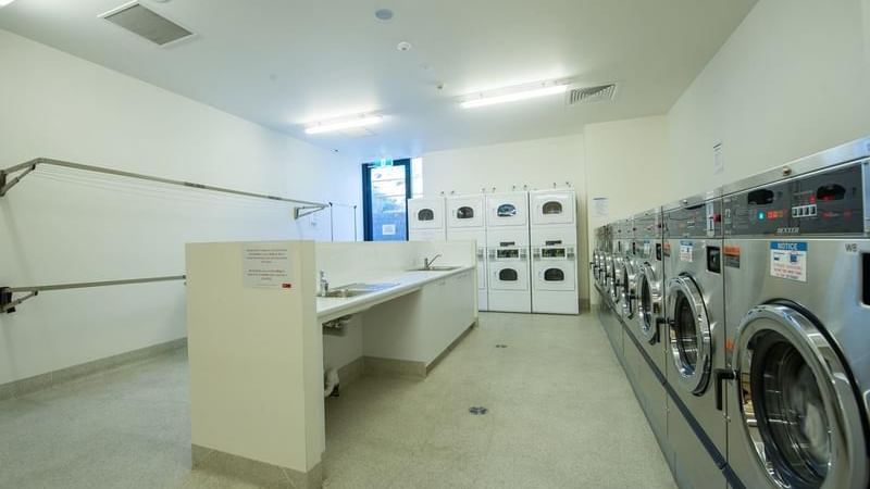 The Laundry is equipped with washing machines, dryers, ironing board, sink & clothes lines