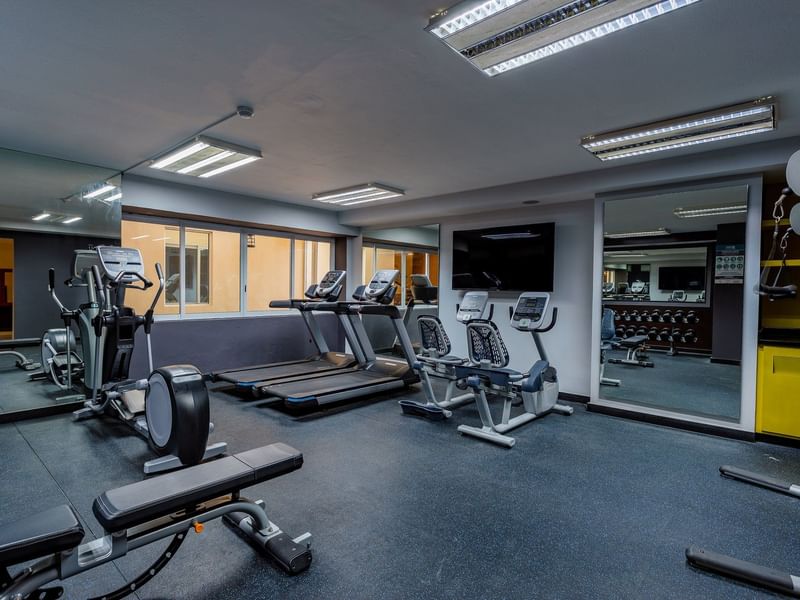 Interior of the fitness center with equipment at Gamma Hotels