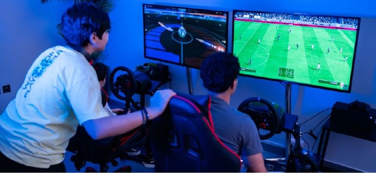 Players immersed in thrilling gaming sessions with football in Level Up - Indoor Gaming Hub at DAMAC Maison Aykon City