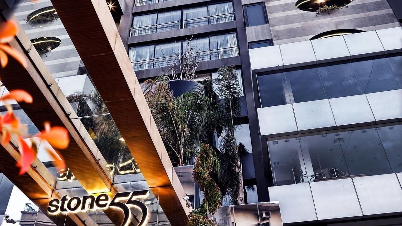 Warwick Stone 55 hotel facade at night with illuminated windows and sign at Warwick Stone 55 - Beirut.