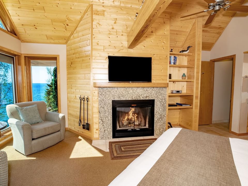 TV, Fireplace & Chair in Superior Master Bed Suite, Bluefin Bay