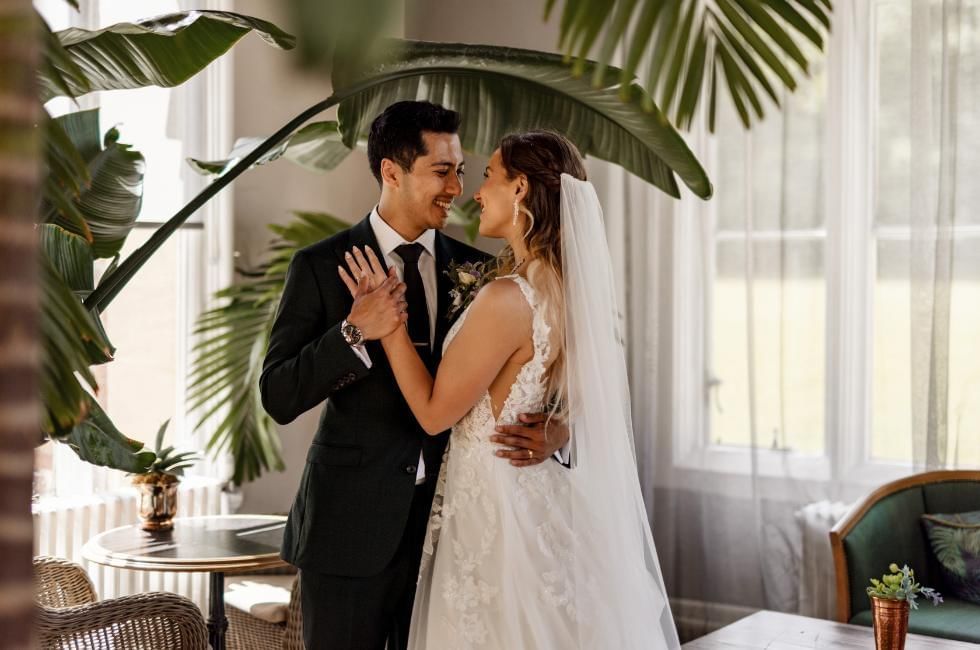 Bride and groom in orangery at Easthampstead Park one of the best wedding venues in Wokingham