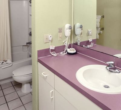 Hotel bathroom with red counter