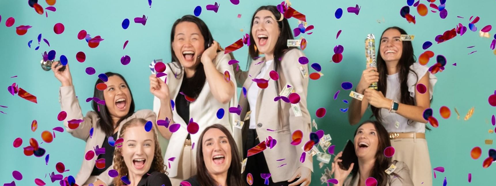 Joyful ladies celebrating with confetti in the air and holding party poppers at Novotel Sydney Olympic Park