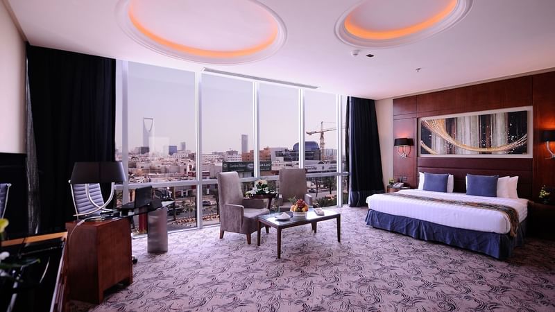 Workspace, bed & lounge area in Panoramic Suite at Al Hamra Palace by Warwick Riyadhd