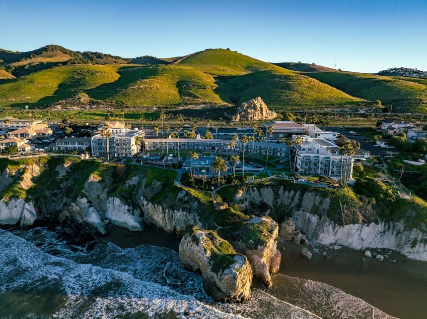 Aerial view of Pismo bluffs with hotels and Pismo Preserve 