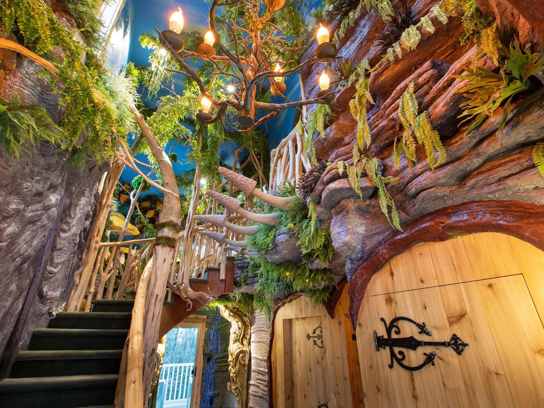 Whimsical The Faerie Forest Cottage with a spiral staircase, natural wood accents, and lush greenery at The Roxbury