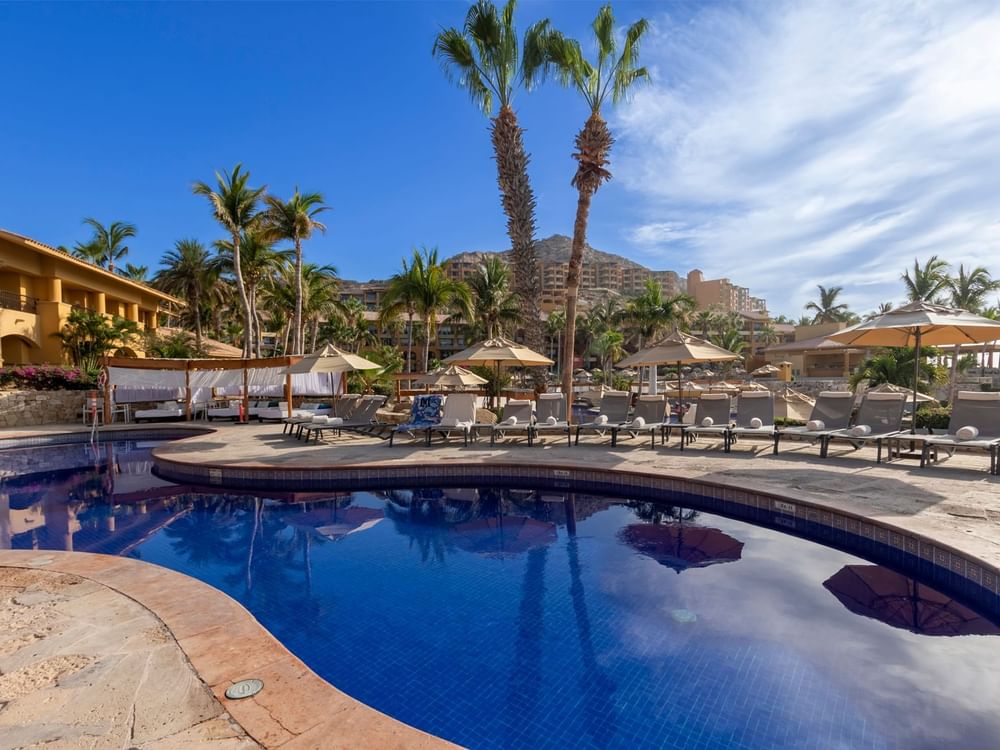 Outdoor Pool area with sun loungers at Grand Fiesta Americana