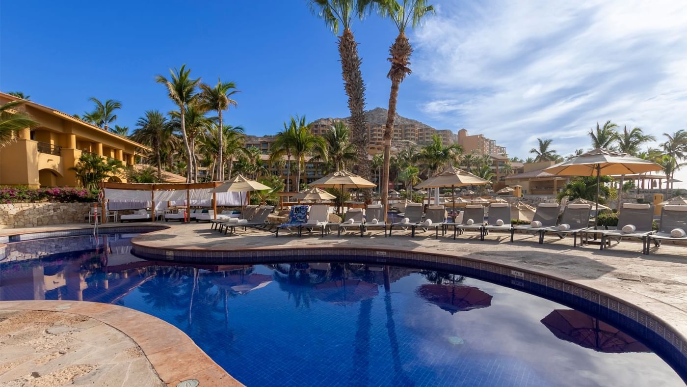 Outdoor pool with sun loungers at Grand Fiesta Americana