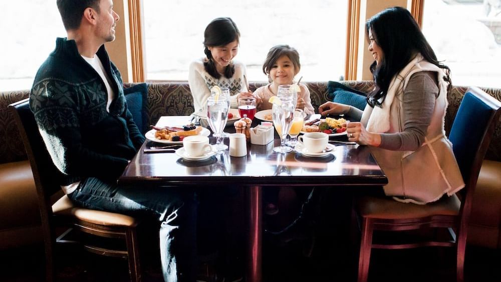 A family enjoying dining at The Chateaux Deer Valley