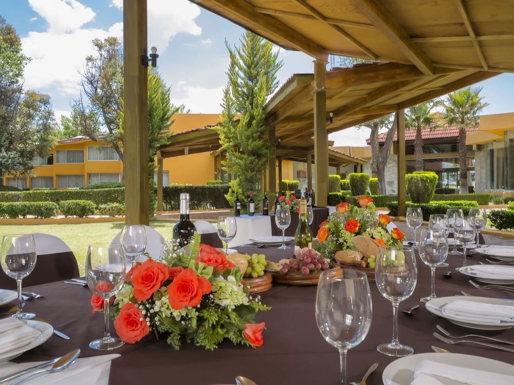 Table arranged with wine & flowers in the Garden at Gamma Pachuca